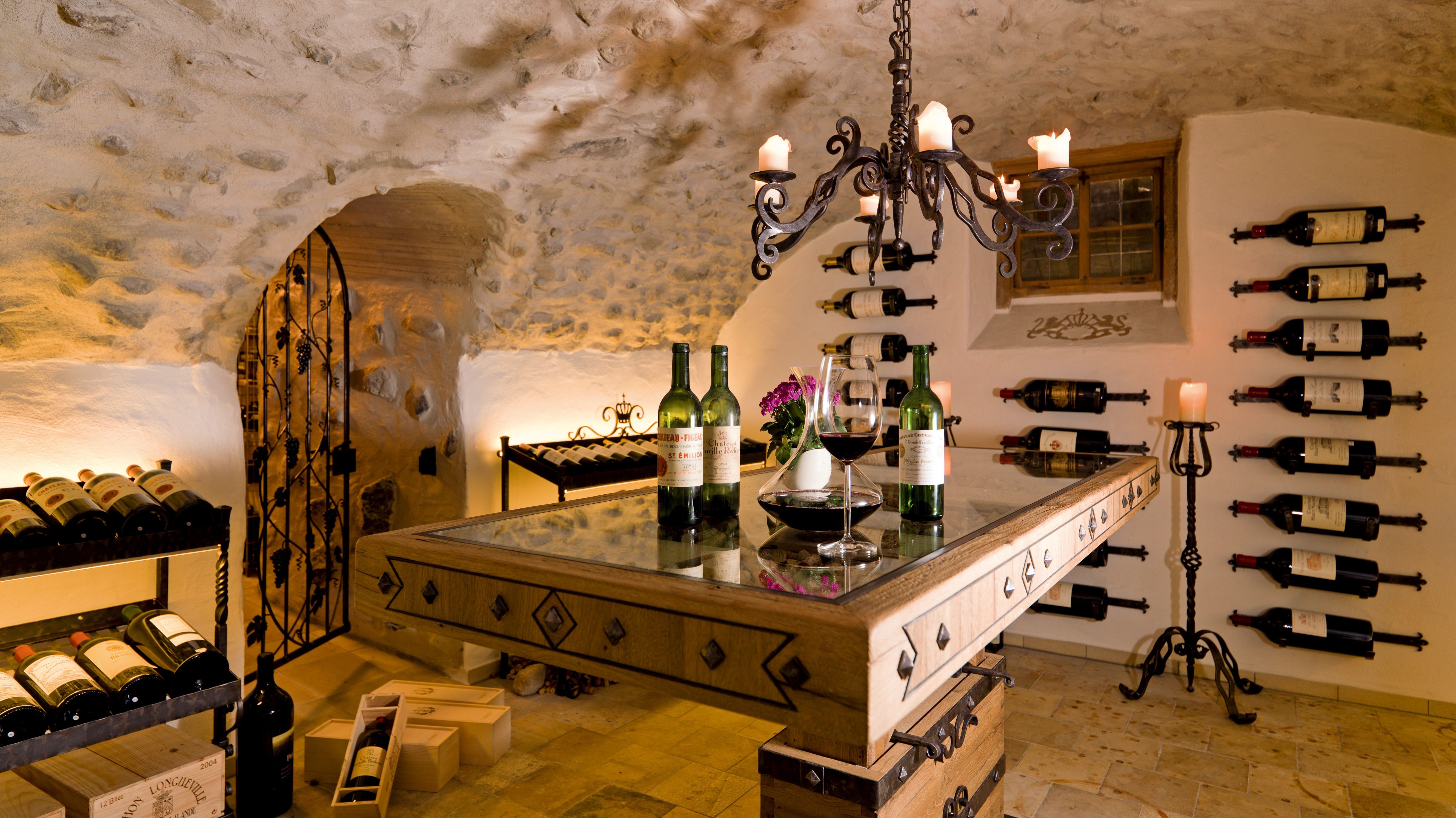 Luxurious wine cellar with stone walls and wooden racks showcasing various wine bottles