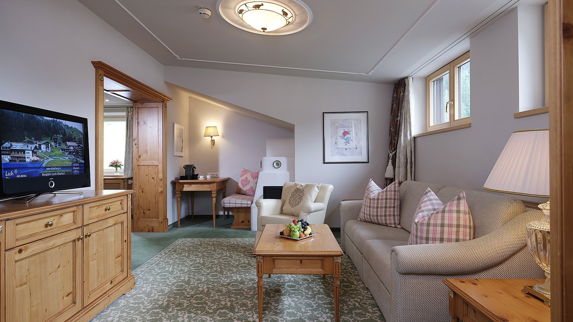 Junior Suite Furnished hotel room with a living area featuring a sofa, coffee table and television